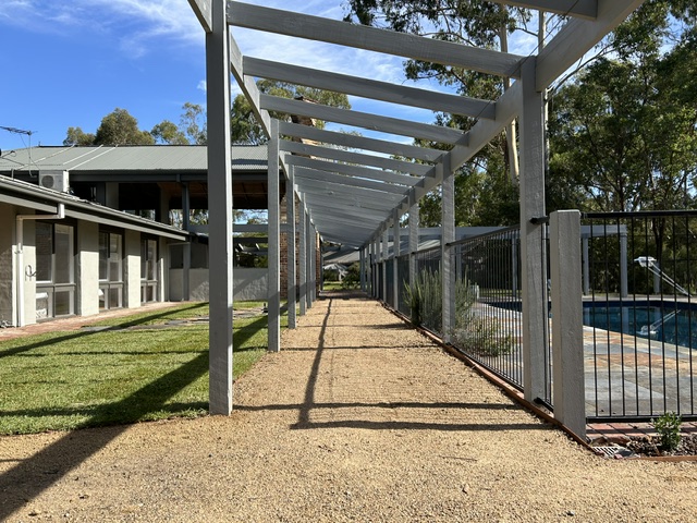 Finished pergola and landscaped pool area